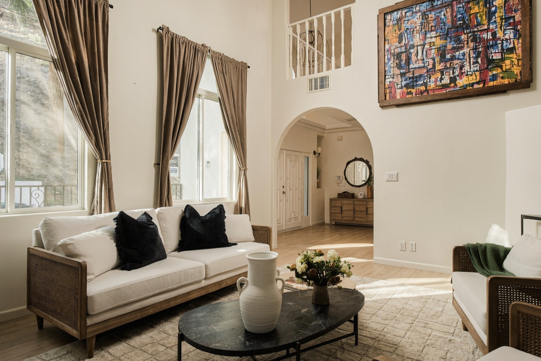 Living room toward the arched passage and the stair